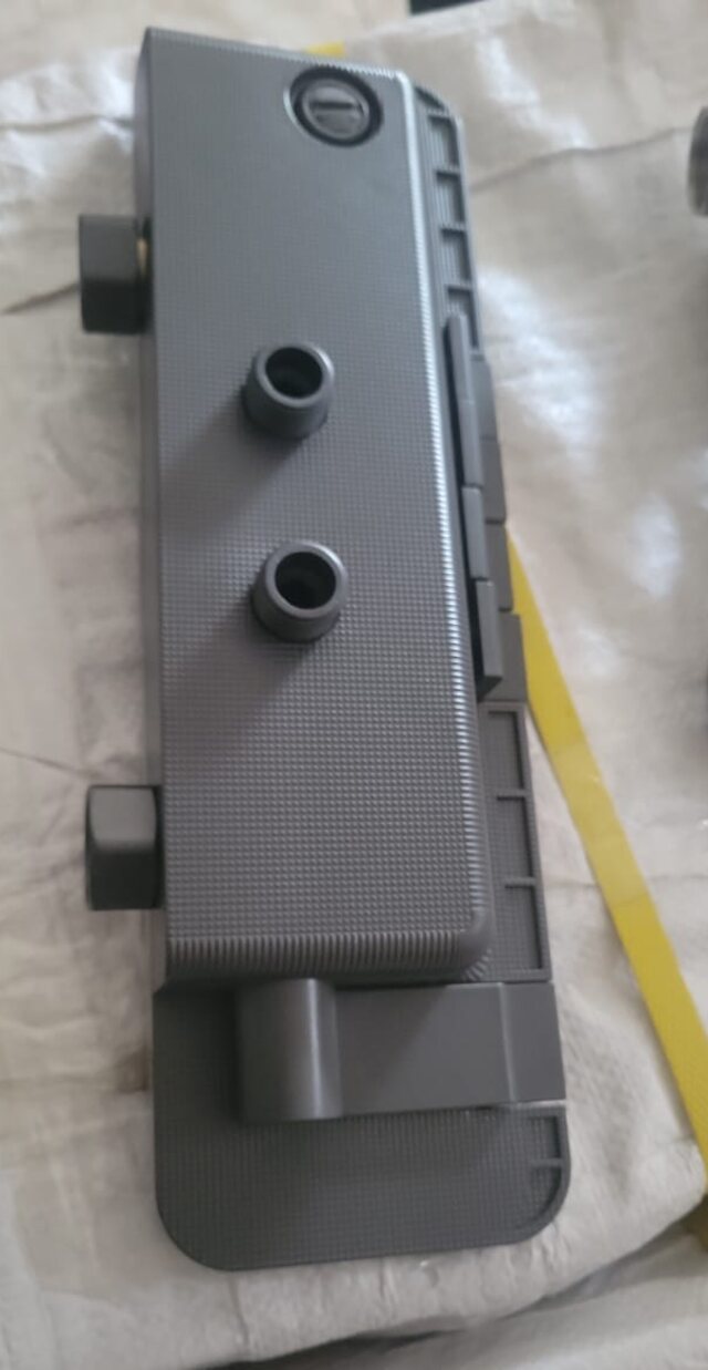 The counterfeit plastic shower panel, a moulded grey shell with no digital display and no piano keys